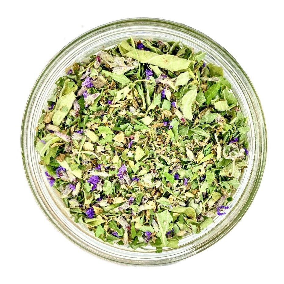 A top-down view of a fully customized handmade loose tea blend in a glass jar