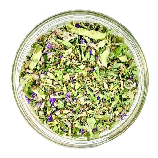 A top-down view of a fully customized handmade loose tea blend in a glass jar